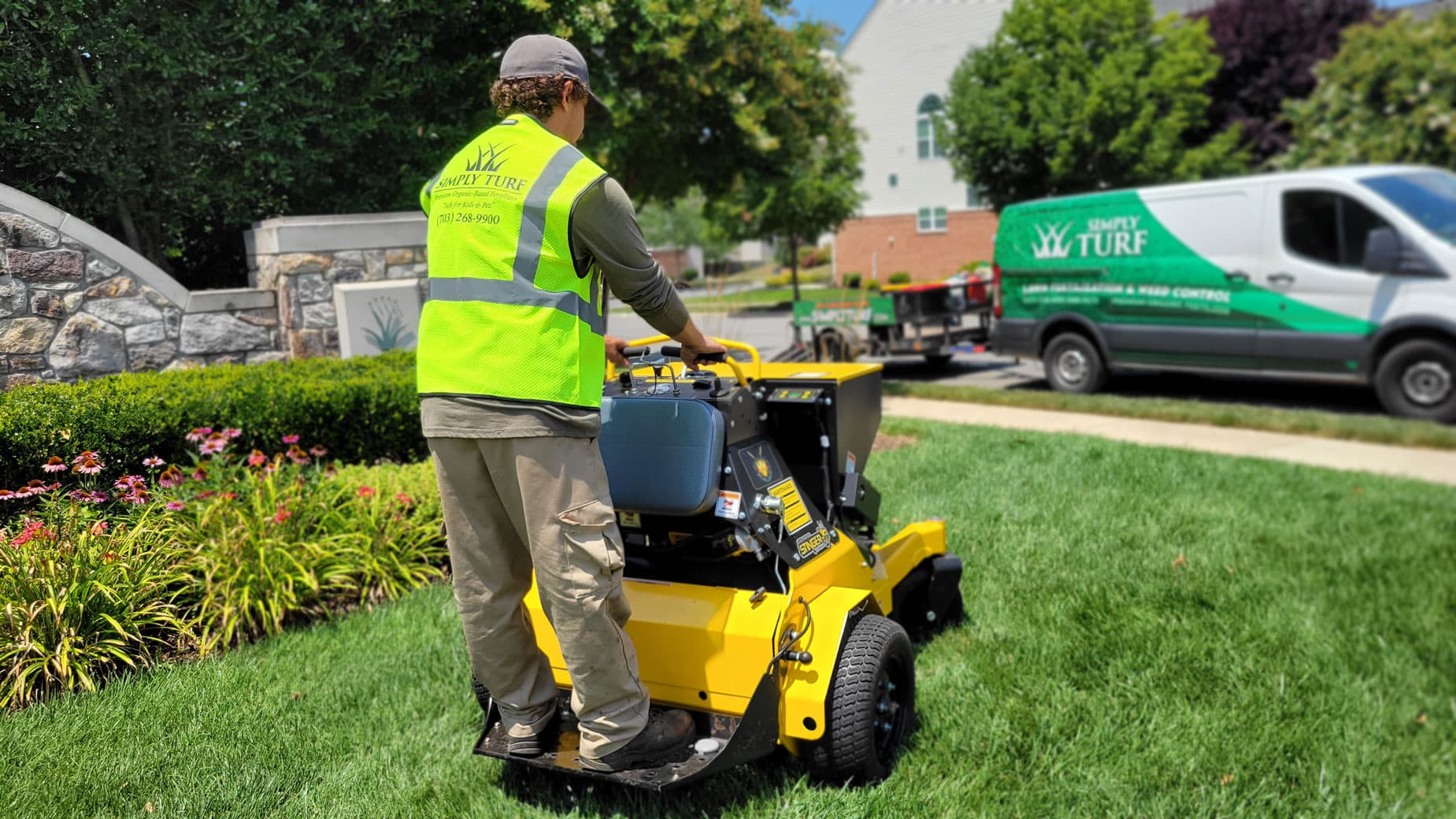 Technician operating a stand-on Stinger aerator